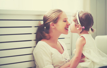 Happy loving family. mother and child playing,  kissing and hugg
