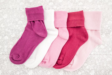 Pink, White and Purple Pair of Child Socks on White Background
