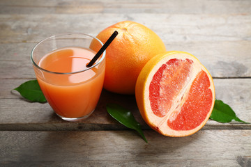 Citrus juice and fresh fruits on black plate