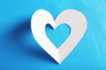 Naklejka na ściany i meble Cut out white paper heart on blue background