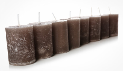 Wax grey candles isolated on white background