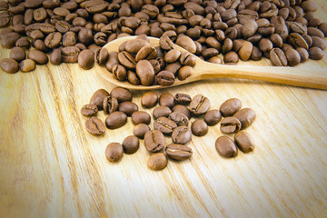 Coffee beans on vintage wooden board