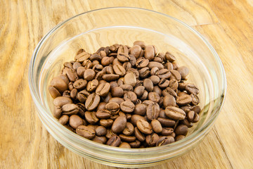 Cup full of coffee beans isolated
