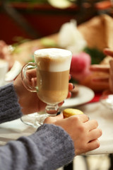 Women meeting in cafe and drinking latte