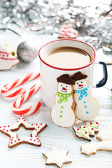 Christmas cookies with cup of hot coffee on a blue wooden table