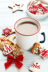 Christmas cookies with cup of hot coffee on a blue wooden table