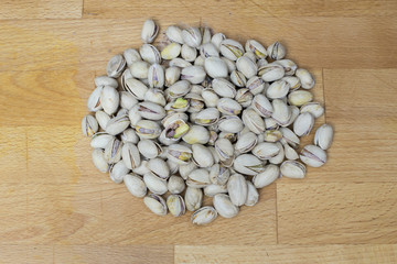 pistachios lying on a wooden background