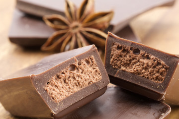 Chocolate bars on wooden background 