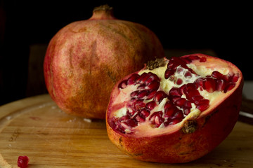 Pomegranates on wooden plate