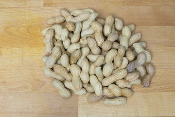 peanuts lying on a wooden bckground