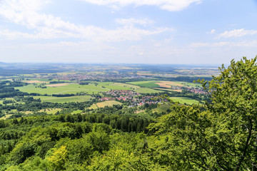 Obraz premium Village countryside with trees and clouds.