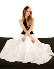 Fototapeta premium woman in dress black vest sit high on couch