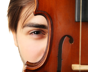 Young handsome man with violin against white background, close up