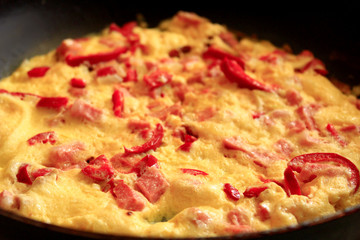 cooking of omelet with red paprika