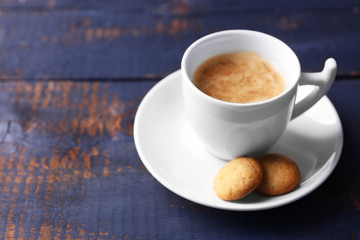 Cup of coffee on wooden table background