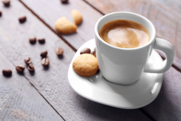 Cup of coffee on wooden table background