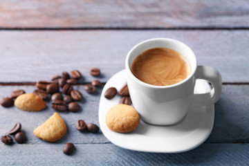 Cup of coffee on wooden table background