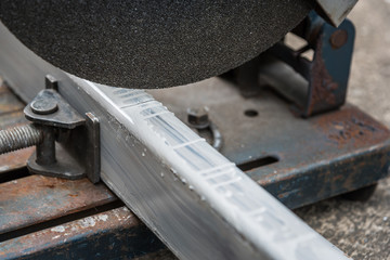 close up cutting a square metal and steel with compound mitre