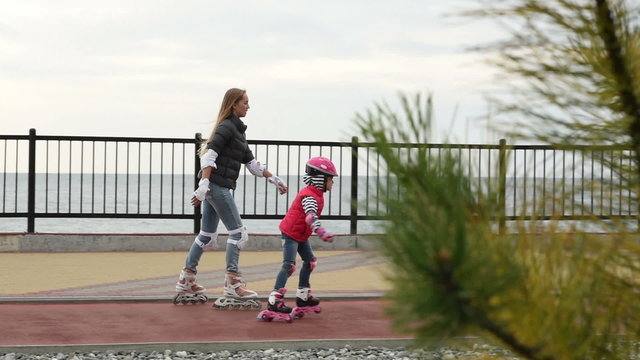 Mom and daughter learn to roller skate