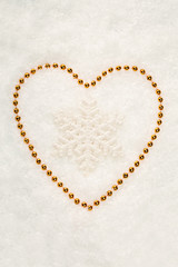 Snowflake in Golden Heart on Snow White Background. Christmas Co