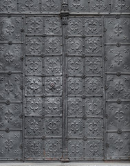 Old church iron door decorated with lilies pattern,