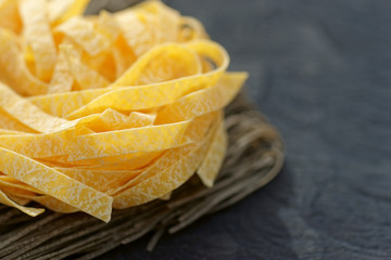 Two types of pasta on wooden plank