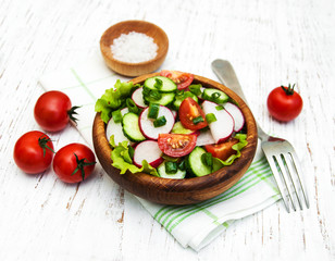 Spring salad with tomato, cucumbers and radish