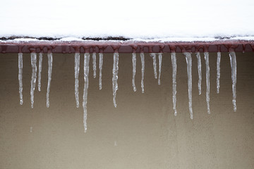 Icicles which are hanging down from a roof