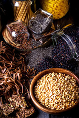 Different types of pasta, rice, peas,seeds of flax and chia on dark wooden table.