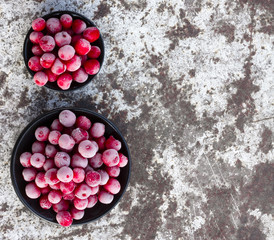 Frozen red cherries on white stripped metal surface. Selective focus. Free space for text. Copy space.