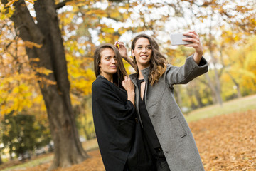 Young women taking selfie with smartphone outdoor