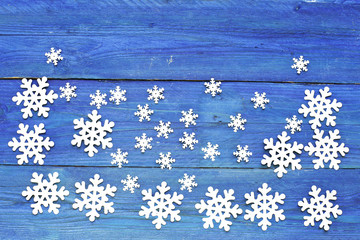 Snowflakes on blue  wooden background