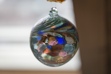A colorful glass sphere in slight blur