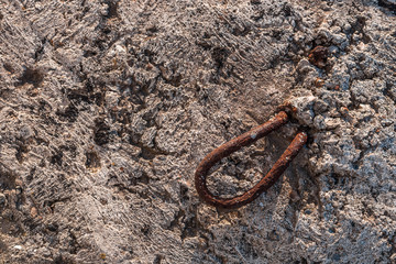 Rusty rebar in the concrete wall. Rust in concrete. Rusty piece of iron.