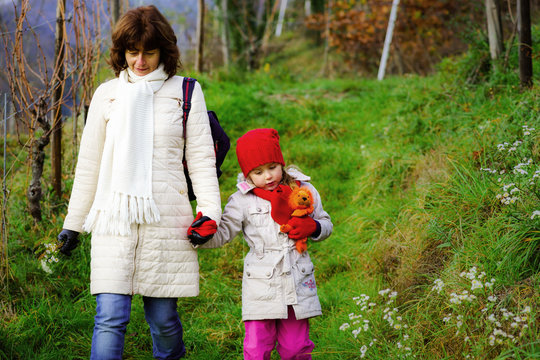 Cute little girl walking with her mother