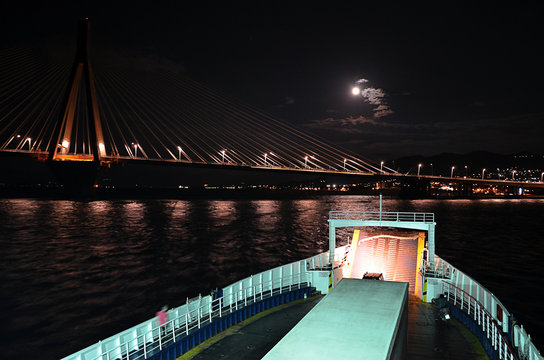 big ferry landing near the bringe at night