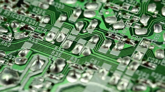 Microcircuit chip with electronic components. Close-up of micro circuit, resistors and chips. Chips and resistors on green circuit board close up. Close up of electronic circuit board, macro lens
