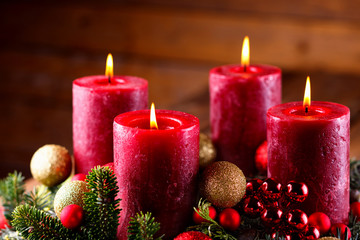Four burning red candles in classic  advent wreath  -- Christmas background