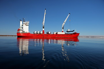 Cargo ship with cranes in Arctic
