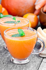 fresh  healthy pulpy cocktail with orange fruits and berries and