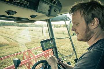 Farmer driving combine harvester