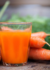 Carrot juice on wooden background