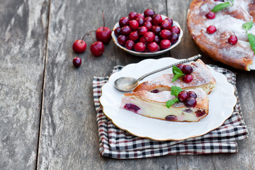 Obraz na płótnie Canvas pieces of cranberry cheesecake tart on a wooden table