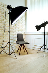 Photo studio with modern interior and lighting equipment
