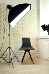 Photo studio with modern interior and lighting equipment