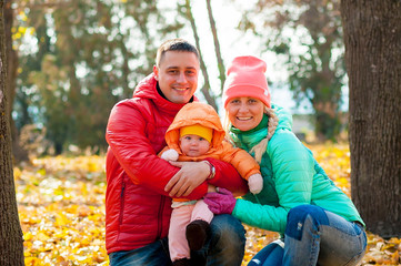 Fototapeta premium Happy family play with child in autumn 