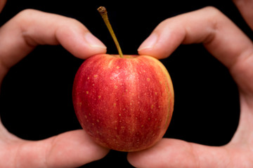 Small Apple hold in hand , close up