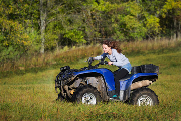 Obraz premium Elegant woman riding extreme quadrocycle ATV