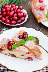 pieces  of cranberry cheesecake tart on a wooden table