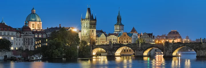 Tuinposter Prague, Czech Republic. Evening panorama of the Charles Bridge with dome of the Saint Francis of Assisi Church, Old Town Bridge Tower, Old Town Water Tower, dome of the National Theatre. © Mikhail Markovskiy